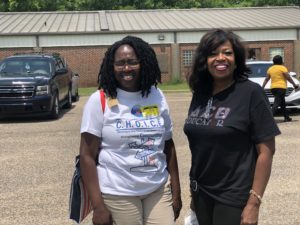 Pictured with Emefa Butler, Executive Director of CHOICE (Choosing to Help Others In our Community Excel) disseminating information, promotional items, and teacher appreciation gifts during Fun Day at Hatch High School, Uniontown Alabama